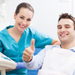Man giving thumbs up at dentist office