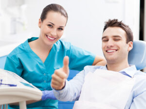 Man giving thumbs up at dentist office